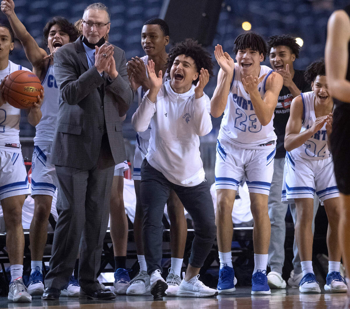 The Curtis bench cheers on the Vikings against Mount Si during the WIAA 4A Boys Basketball State Championship game in the Tacoma Dome in Tacoma, Washington, on Saturday, March 5, 2022.