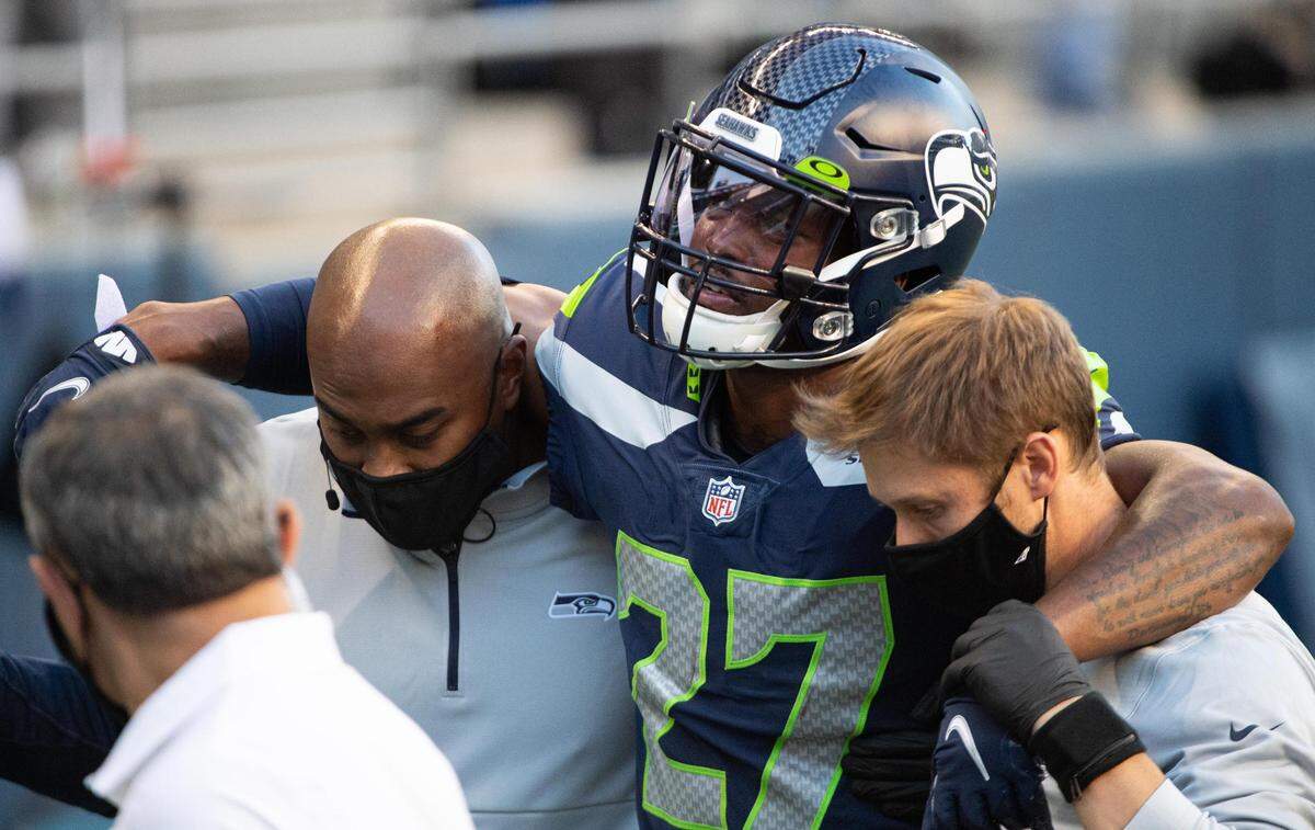 Seattle Seahawks safety Marquise Blair (27) is helped off the field after a leg injury. The Seattle Seahawks played the New England Patriots in a NFL football game at CenturyLink Field in Seattle, Wash., on Sunday, Sept. 20, 2020.