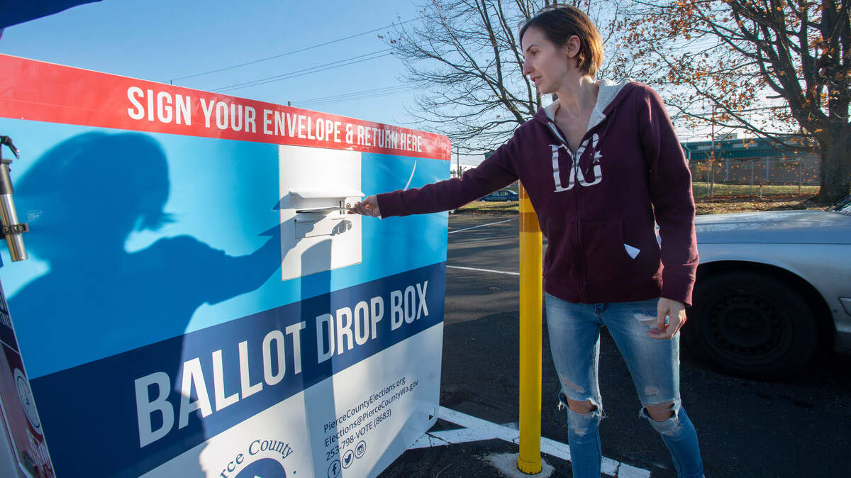 Julie Nielsen deposits her ballot in the Pierce County Annex drop box on Election Day, Tuesday, Nov. 5, 2019.