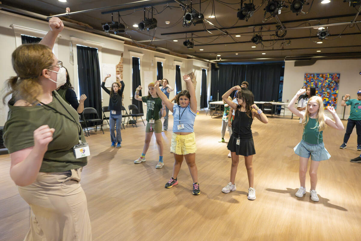 Director of Education Jill Heinecke, left, leads Performers' Pathway summer camp participants through a round of choreography during the theater camp with Tacoma Arts Live on Wednesday, July 29, 2026, at the Tacoma Armory in Tacoma, Wash.