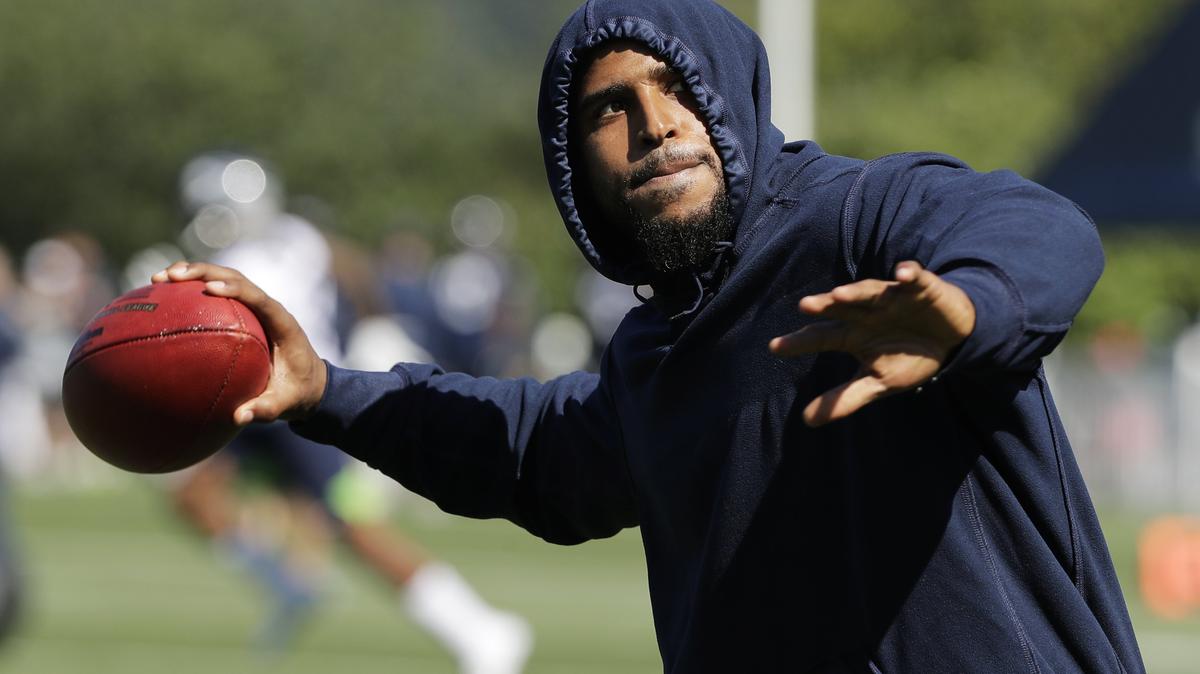 Seattle Seahawks linebacker Bobby Wagner pretends to throw a football to fans during NFL football training camp, Thursday, July 25, 2019, in Renton, Wash. (AP Photo/Ted S. Warren)