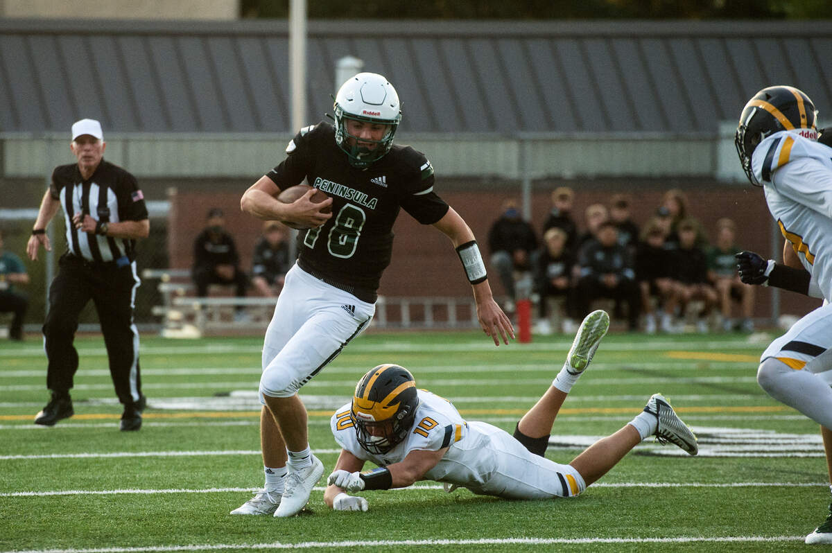 Peninsula High School quarterback Jake Bice scrambles for a first down during during a football game against Bellevue on Friday, Sept. 3, 2021 at Roy Anderson Field in Purdy, Wash.