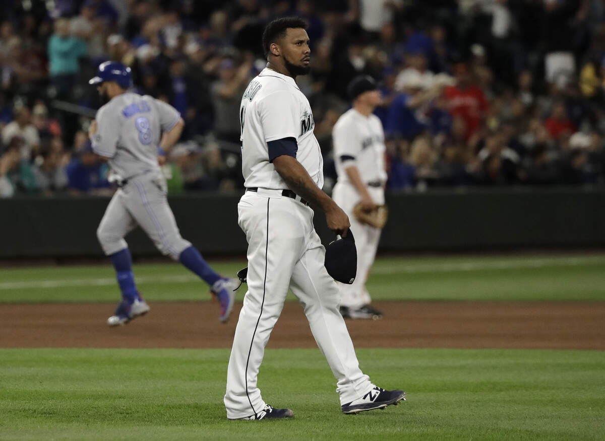 Seattle Mariners pitcher Juan Nicasio center, waits as Toronto Blue Jays’ Kendrys Morales, left, rounds the bases after hitting a two-run home run during the seventh inning of a baseball game Thursday, Aug. 2, 2018, in Seattle. (AP Photo/Ted S. Warren)