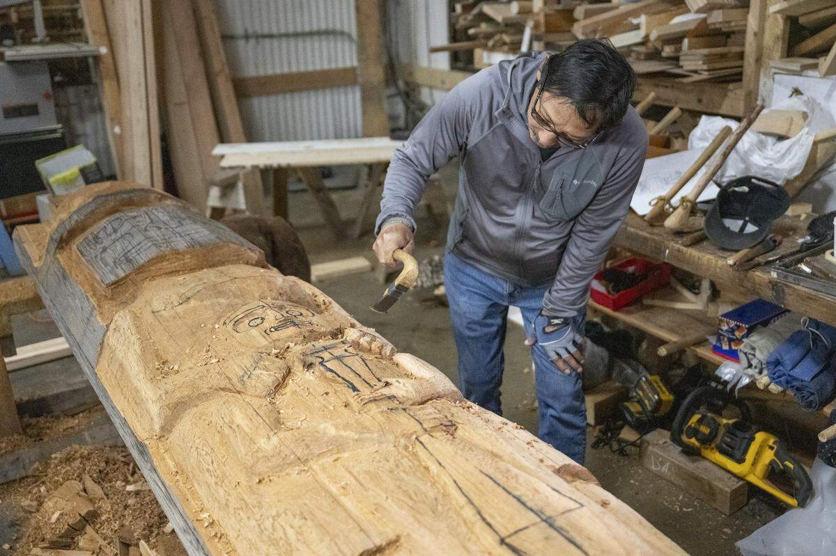 Al Zantua works on welcome figures for Quileute Tribal School new school building on Friday, April 24, 2026, in the workshop of Tacoma Boat Builders in Tacoma, Wash. Zantua, a former principal at Quileute Tribal School, has been working in the space since the fall.