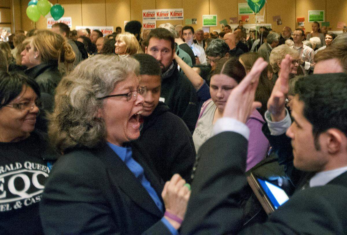 State Rep. Laurie Jinkins cheers and slaps hands with Tacoma council member Ryan Mello at an election night party for Democrats held at the Hotel Murano in downtown Tacoma, November 6, 2012. Peter Haley / Staff photographer
