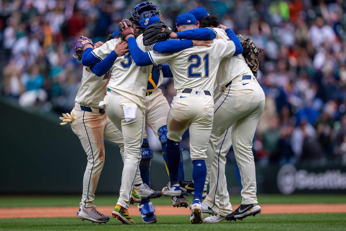 Apr 27, 2025; Seattle, Washington, USA;  Seattle Mariners including shortstop J.P. Crawford (3) and second baseman Miles Mastrobuoni (21) celebrates after a gamem against the Miami Marlins at T-Mobile Park. Mandatory Credit: Stephen Brashear-Imagn Images