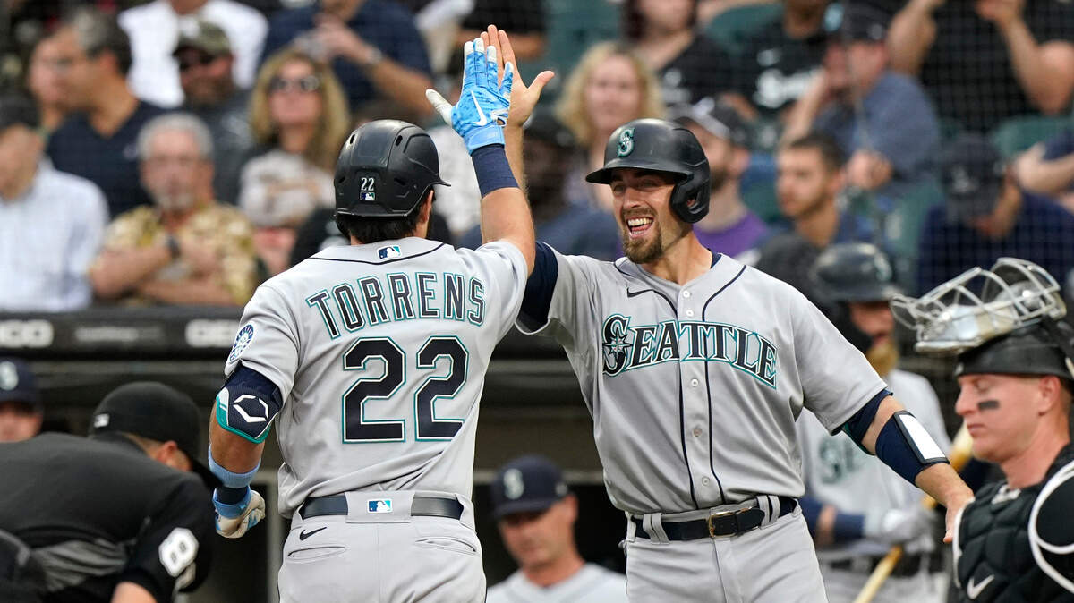 Seattle Mariners’ Luis Torrens, left, celebrates with Tom Murphy after hitting a two-run home run during the second inning of a baseball game against the Chicago White Sox in Chicago, Friday, June 25, 2021. (AP Photo/Nam Y. Huh)