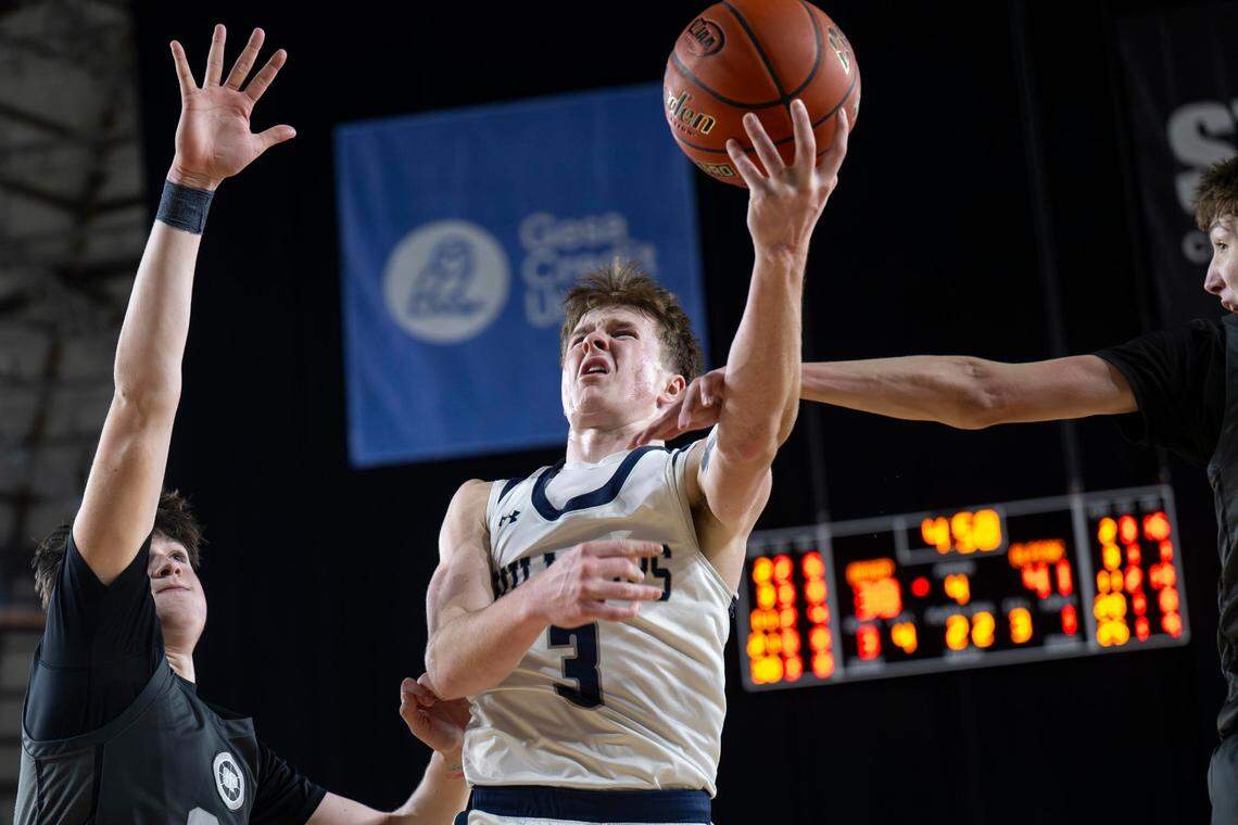 Gonzaga Prep guard Hudson Floyd (3) attempts a layup as he is fouled by Glacier Peak forward Jack Taylor (3) during the fourth quarter of a Class 4A state basketball tournament semifinal game at the Tacoma Dome on Friday, March 7, 2025, in Tacoma, Wash.