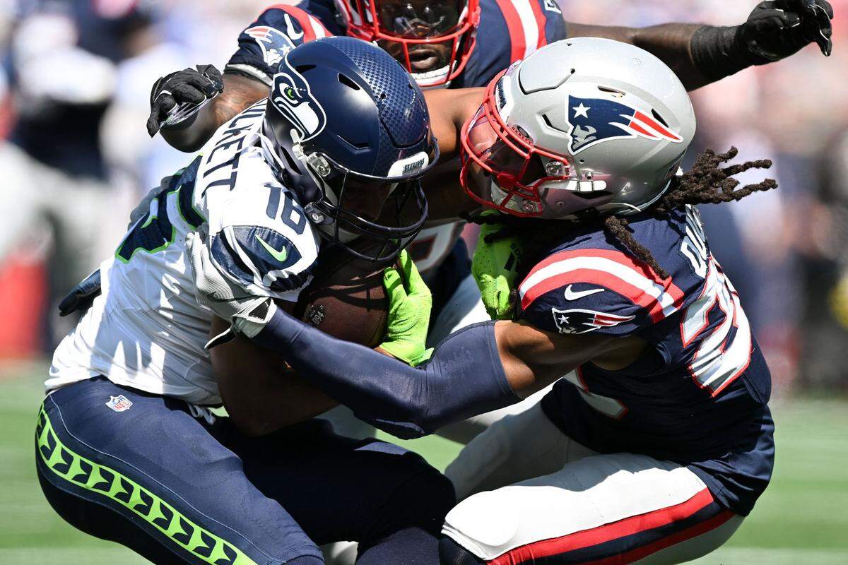 Sep 15, 2024; Foxborough, Massachusetts, USA; New England Patriots safety Kyle Dugger (23) tackles Seattle Seahawks wide receiver Tyler Lockett (16) during the first half at Gillette Stadium. Mandatory Credit: Brian Fluharty-Imagn Images