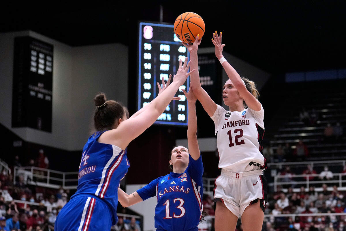 Stanford guard Lexie Hull (12) shoots over Kansas center Danai Papadopoulou (14) and guard Holly Kersgieter (13) during the second half of a second-round game in the NCAA women’s college basketball tournament Sunday, March 20, 2022, in Stanford, Calif. (AP Photo/Tony Avelar)