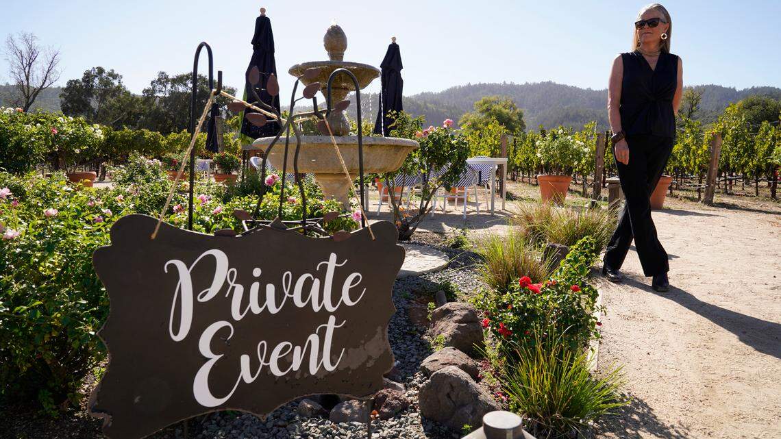 Event planner Janice Twomey looks over a garden area where weddings were often held near Oakville, Calif., on Thursday, Oct. 15, 2020. (AP Photo/Eric Risberg)