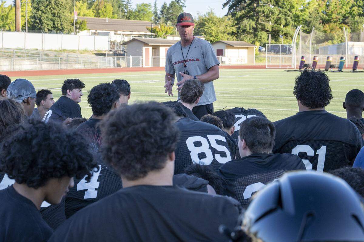 Franklin Pierce head coach Trevor Hanson, center, talks with players after a team practice on Wednesday, Aug. 20, 2025, in Tacoma, Wash.