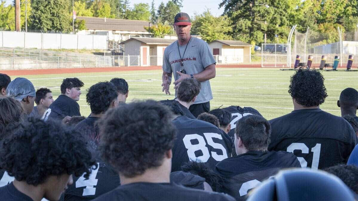 Franklin Pierce head coach Trevor Hanson, center, talks with players after a team practice on Wednesday, Aug. 20, 2025, in Tacoma, Wash.