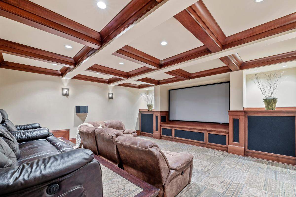 The bottom level of the home offers multiple entertainment features, including an in-home movie theater.