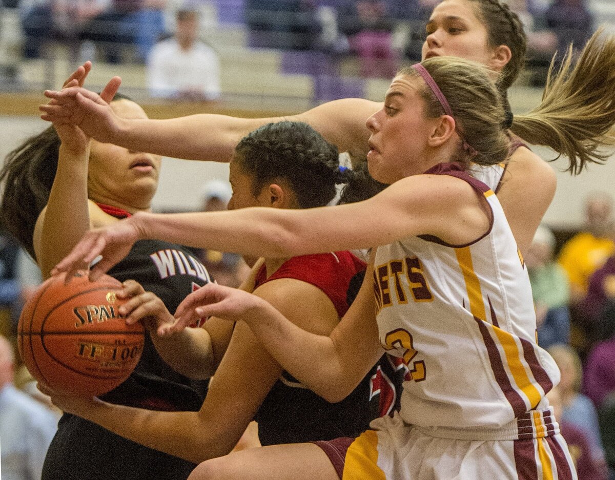 Lee Audrey Norris (foreground) and Sam Fiedler (top) of White River High School battle for the ball in a girls AA basketball playoff game at Puyallup High, February 23, 2019. White River at Archbishop Murphy.