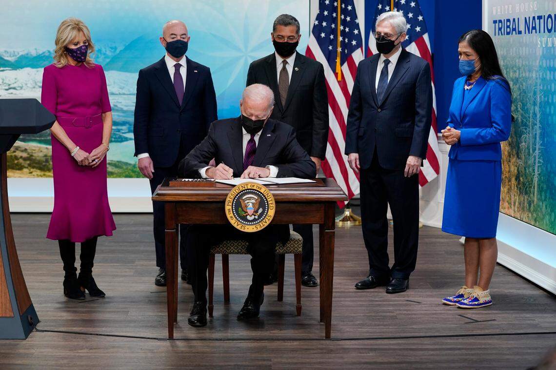 President Joe Biden signs an executive order to help improve public safety and justice for Native Americans during a Tribal Nations Summit during Native American Heritage Month, in the South Court Auditorium on the White House campus, Monday, Nov. 15, 2021, in Washington D.C.. With the President from left are first lady Jill Biden, Homeland Security Secretary Alejandro Mayorkas, Health and Human Services Secretary Xavier Becerra, Attorney General Merrick Garland and Interior Secretary Deb Haaland.