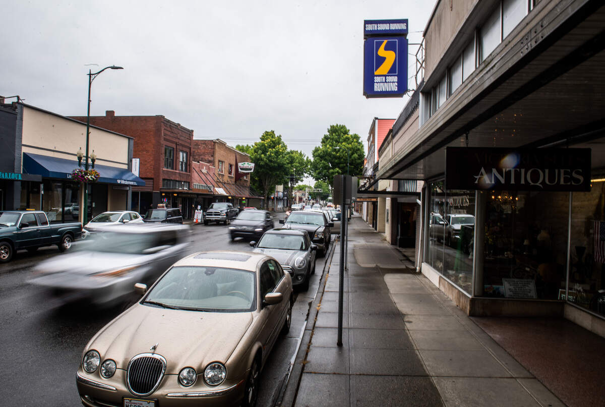 Cars drive through downtown Puyallup, Wash., on Saturday, May 16, 2020.