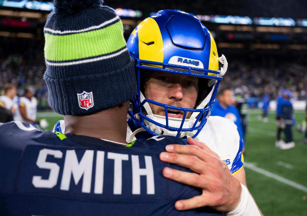 Los Angeles Rams quarterback Matthew Stafford (9) and Seattle Seahawks quarterback Geno Smith (7) talk after the Los Angeles Rams 26-20 overtime victory at Lumen Field, on Sunday, Nov. 3, 2024 in Seattle, Wash.