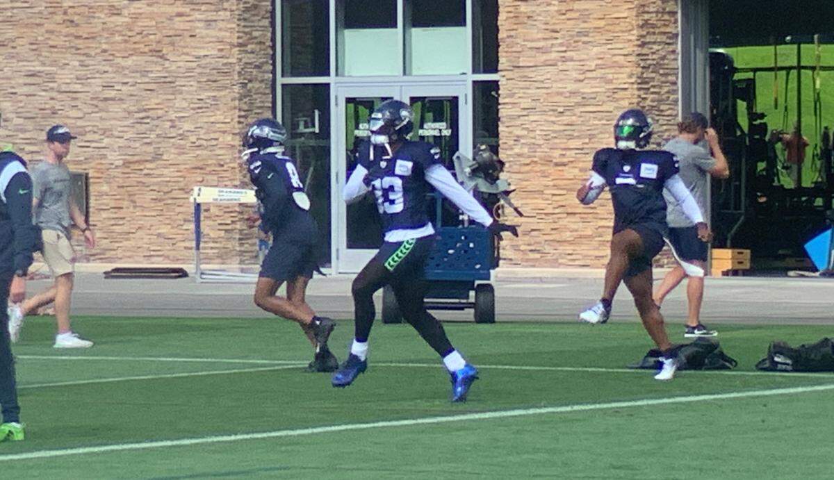 Jamal Adams (center, white sleeves) joins teammates participating in the start of practice at Seahawks headquarters in Renton on Sept. 13, 2023. It was Adams’ first time practicing since he tore his quadriceps tendon in September 2022.
