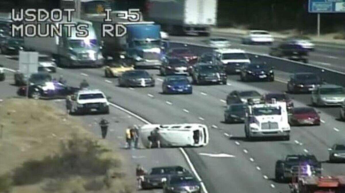 First responders address a rollover crash on southbound Interstate 5 near the Mounts Road exit on Wednesday afternoon.