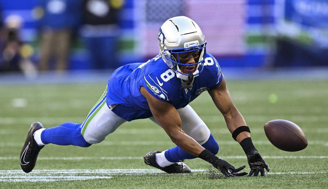 Seattle Seahawks safety Coby Bryant (8) dives for a stray pass from Minnesota Vikings quarterback Max Brosmer (12) during the first quarter of the game at Lumen Field, on Sunday, Nov. 30, 2025, in Seattle.