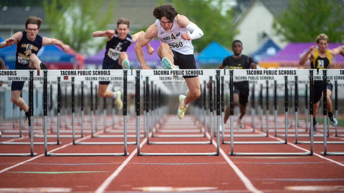 Sehome’s Carter Birade jumps over the final hurdle before crossing the finish line in first place during the second heat of the 110-meter hurdles at the State 2A, 3A, 4A track and field championships on Thursday, May 26, 2022, at Mount Tahoma High School in Tacoma Wash.