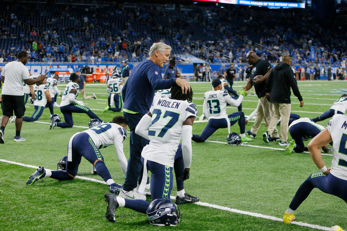 Seattle Seahawks head coach Pete Carroll walks next to cornerback Tariq Woolen during pregame of an NFL football game, Sunday, Oct. 2, 2022, in Detroit. (AP Photo/Duane Burleson)