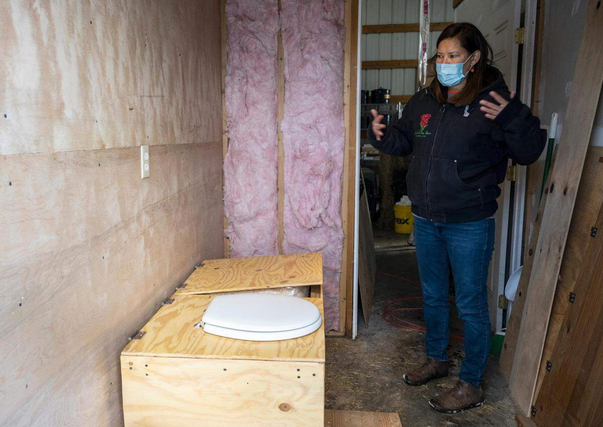 Melissa Meyer, Rose Island Farm owner, shows a recent project that was built at the farm, where she will be using human waste for composting on Thursday, Feb. 24, 2022, in Tacoma, Wash. Rose Island Farm is an Indigenous-owned family farm that provides skill share workshops, food and herbal supports for the BIPOC community.