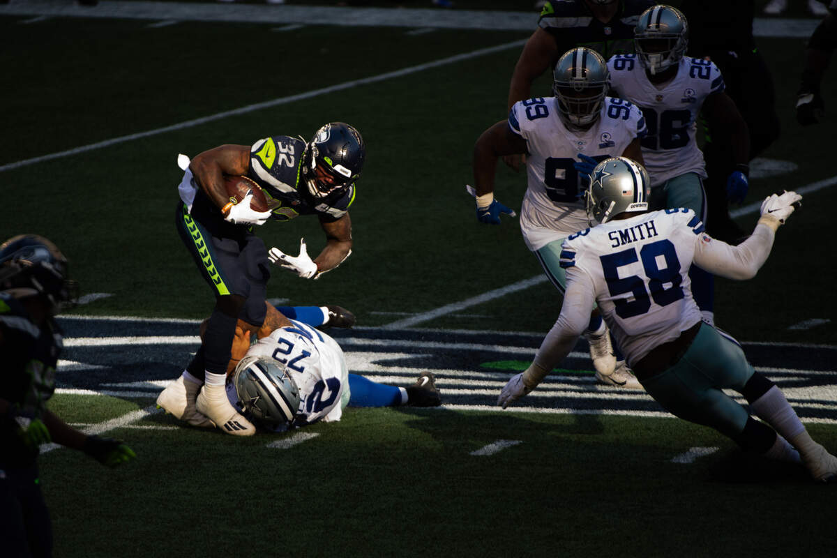 Seattle Seahawks running back Chris Carson (32) is injured while tackled by Dallas’ Trysten Hill during the fourth quarter. The Seattle Seahawks played the Dallas Cowboys in a NFL football game at CenturyLink Field in Seattle, Wash., on Sunday, Sept. 27, 2020.