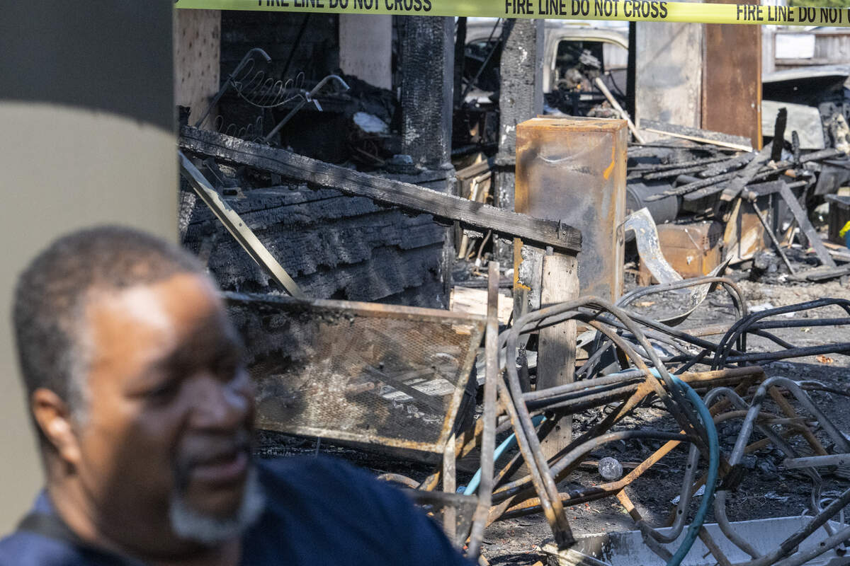 Debris from the fire that destroyed Bishop Enoch Brooks’ house over the weekend is visible behind him as he speaks with the News Tribune on Thursday, Sept. 18, 2025, in Tacoma.