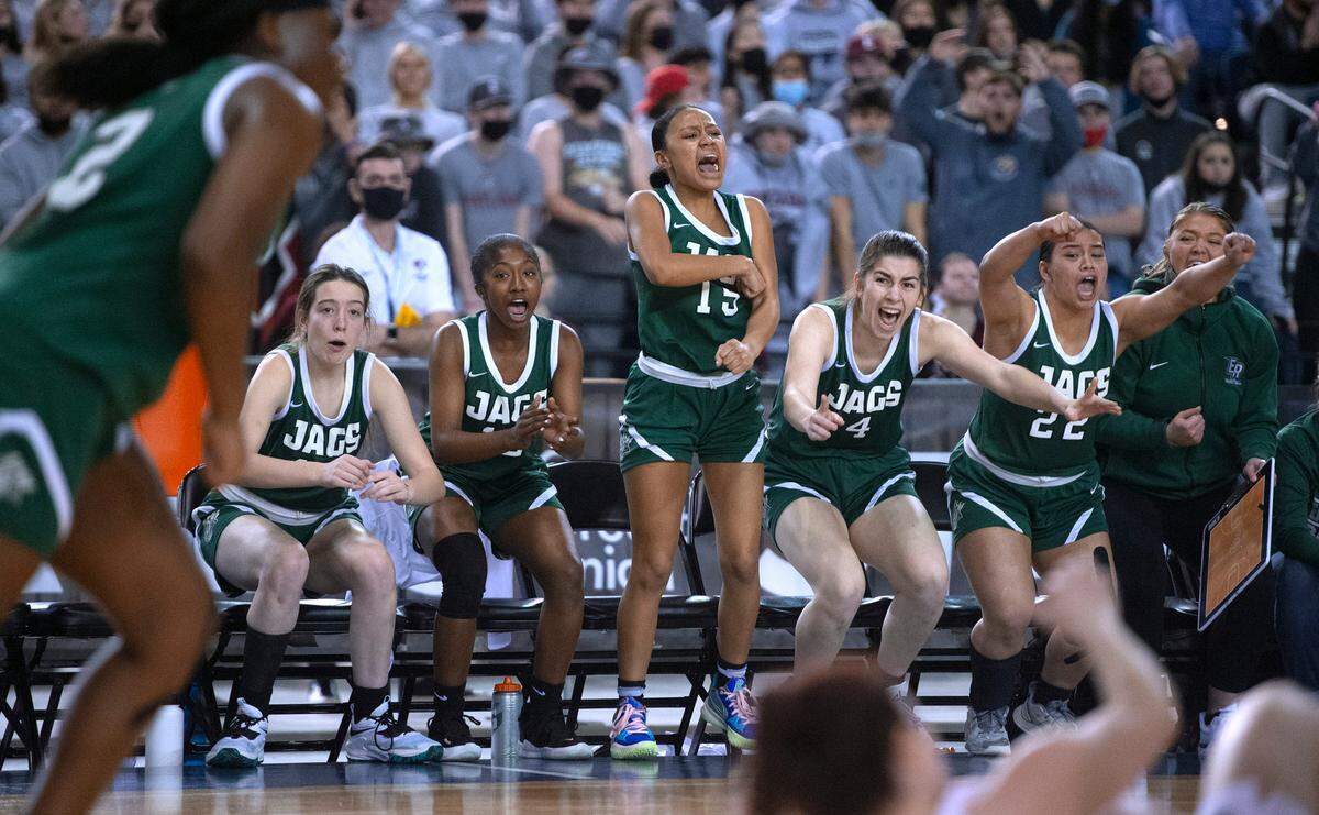 The Emerald Ridge bench erupts as the Jaguars claw their way back from 13 points down to tie the game late against the Eastlake Wolves in Thursday morning’s quarterfinal game of the WIAA 3A Girls Basketball State Championships tournament in the Tacoma Dome in Tacoma, Washington, on Thursday, March 3, 2022.