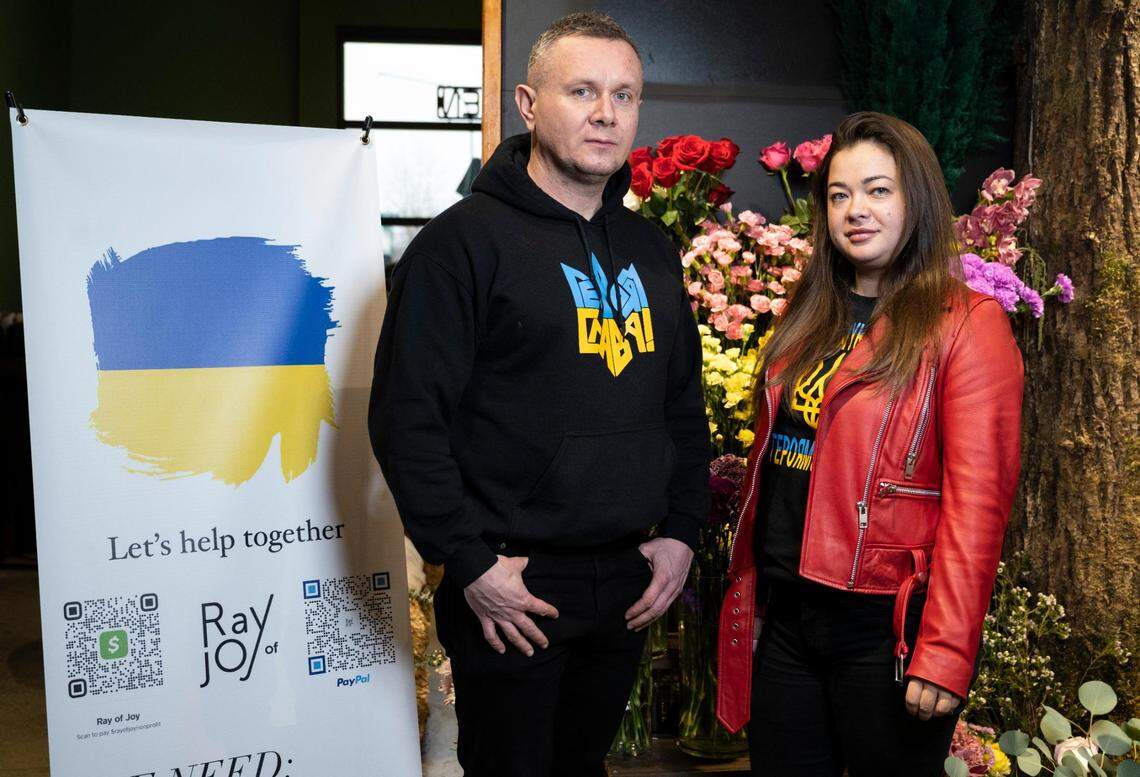 Emish Market general manager Yuri Kovalchuk and chief financial officer Olena Murphy pose for a portrait at the store in Fife, Wash. on Monday, March 14, 2022. Both Kovalchuk and Murphy moved to the United States from Ukraine approximately eight years ago, and have family there currently stuck in the war. There are signs around the store where customers can donate or show support for Ukraine and their families and friends.