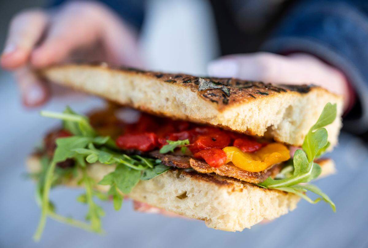 Tucker serves his housemade porchetta on focaccia with roasted peppers, lemon, arugula and garlic aioli. It stands out in a city with enough roast beef au jus.