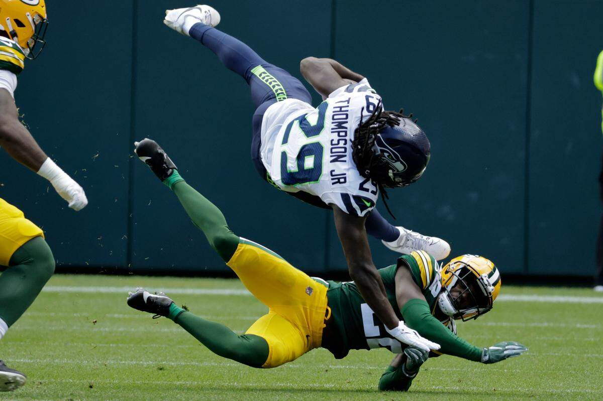 Seattle Seahawks running back SaRodorick Thompson Jr. (29) is tackled by Green Bay Packers cornerback Shemar Jean-Charles (22) in the second half of a preseason NFL football game, Saturday, Aug. 26, 2023, in Green Bay, Wis. (AP Photo/Mike Roemer)