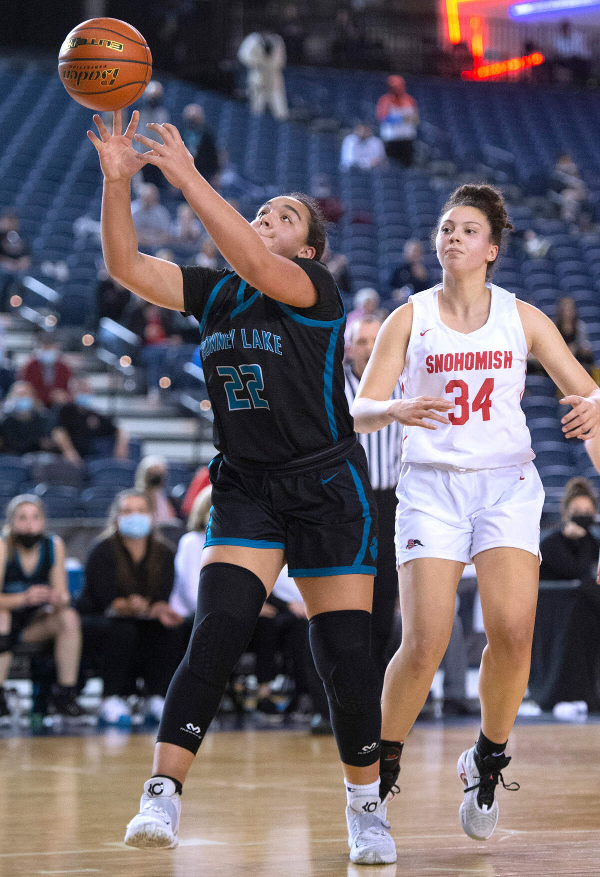 Bonney Lake post Jazmyn Shipp reaches for a rebound in front of Snohomish’s Tyler Gildersleeve-Stiles during Wednesday evening’s opening-round game of the WIAA 3A Girls Basketball State Championships tournament in the Tacoma Dome in Tacoma, Washington, on Wednesday, March 2, 2022. Snohomish won the game, 46-44.