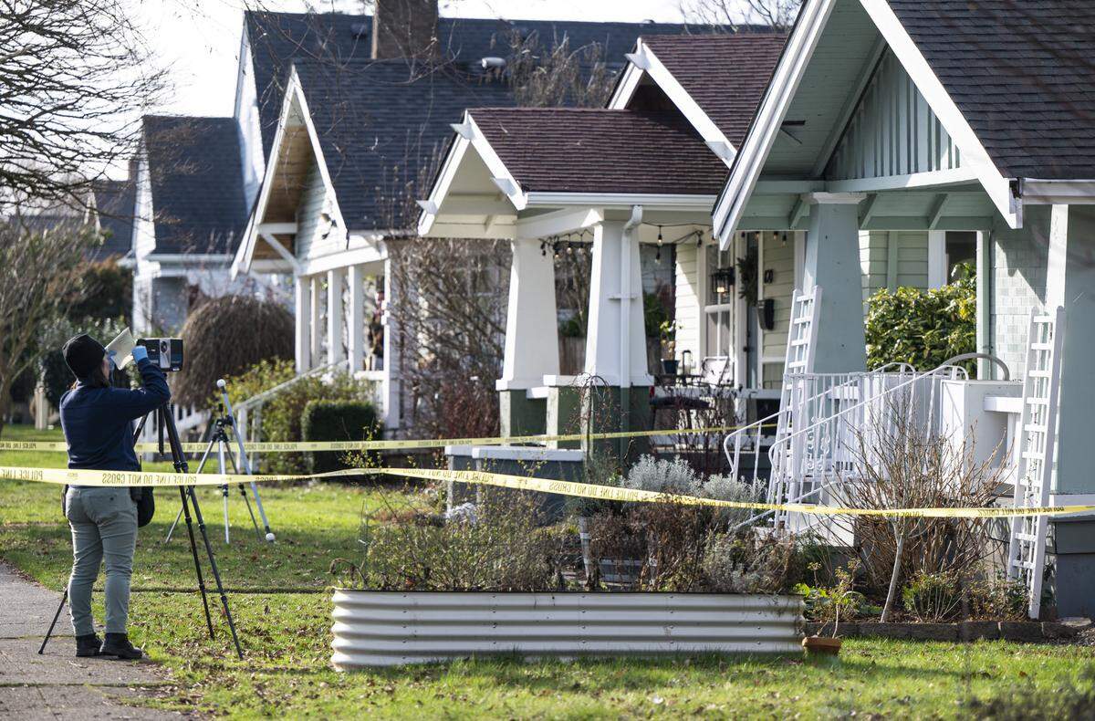Crime scene technicians investigate the scene where a 66-year-old woman was found dead inside her Central Tacoma residence after she called 911 asking for help for her son, who she said was having a mental health crisis, at the 800 block of South Anderson Street in Tacoma, Wash. on Feb. 1, 2023.