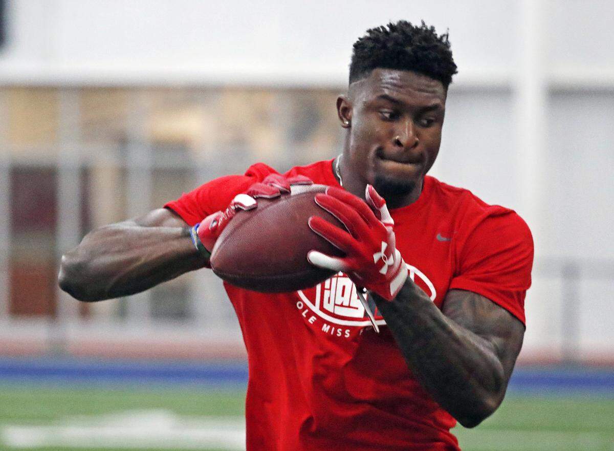 Former Mississippi football wide receiver DK Metcalf catches a pass while running pass patterns runs as he is tested by NFL scouts and coaches during Pro Day at Mississippi, Friday, March 29, 2019, in Oxford, Miss. (AP Photo/Rogelio V. Solis)