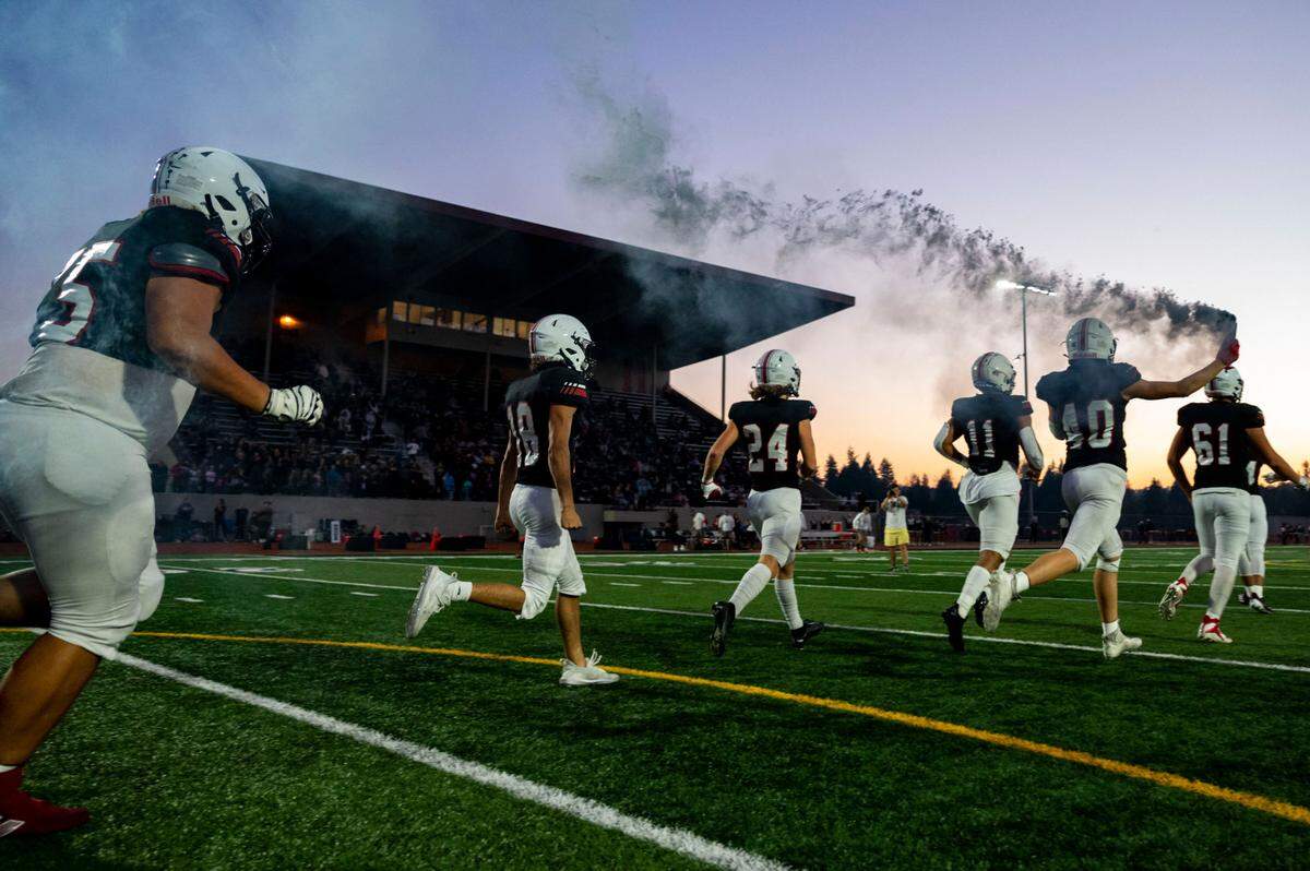 Yelm players run onto the field prior to the start of a 3A SSC game against Timberline on Thursday, Oct. 13, 2022, at Yelm High School in Yelm, Wash.
