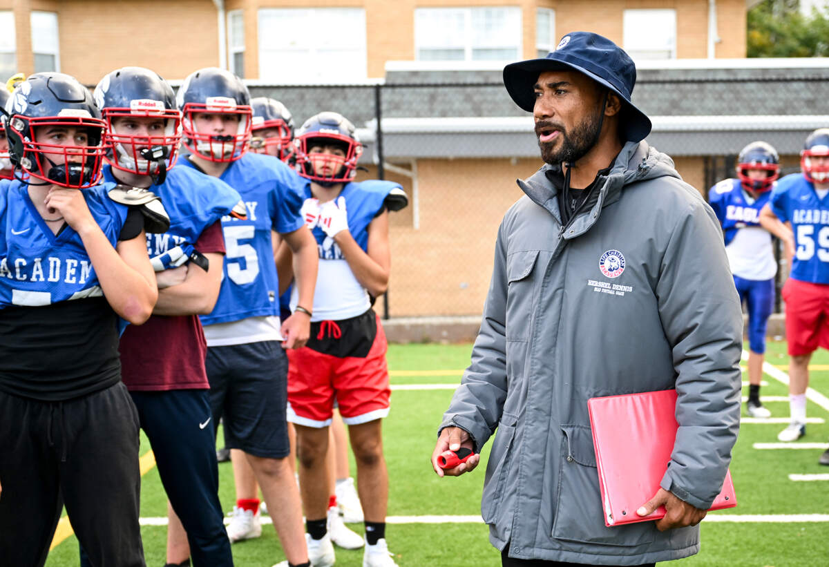 Life Christian Academy head football coach Hershel Dennis speaks to players as they run drills during a practice at Life Christian Academy, Wednesday, Oct. 11, 2023, in Tacoma, Wash. Dennis is a two-time national title winning running back at USC and one of the winningest athletes in college football.