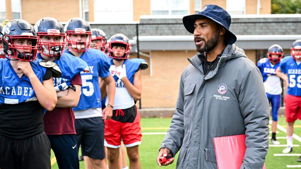 Life Christian Academy head football coach Hershel Dennis speaks to players as they run drills during a practice at Life Christian Academy, Wednesday, Oct. 11, 2023, in Tacoma, Wash. Dennis is a two-time national title winning running back at USC and one of the winningest athletes in college football.
