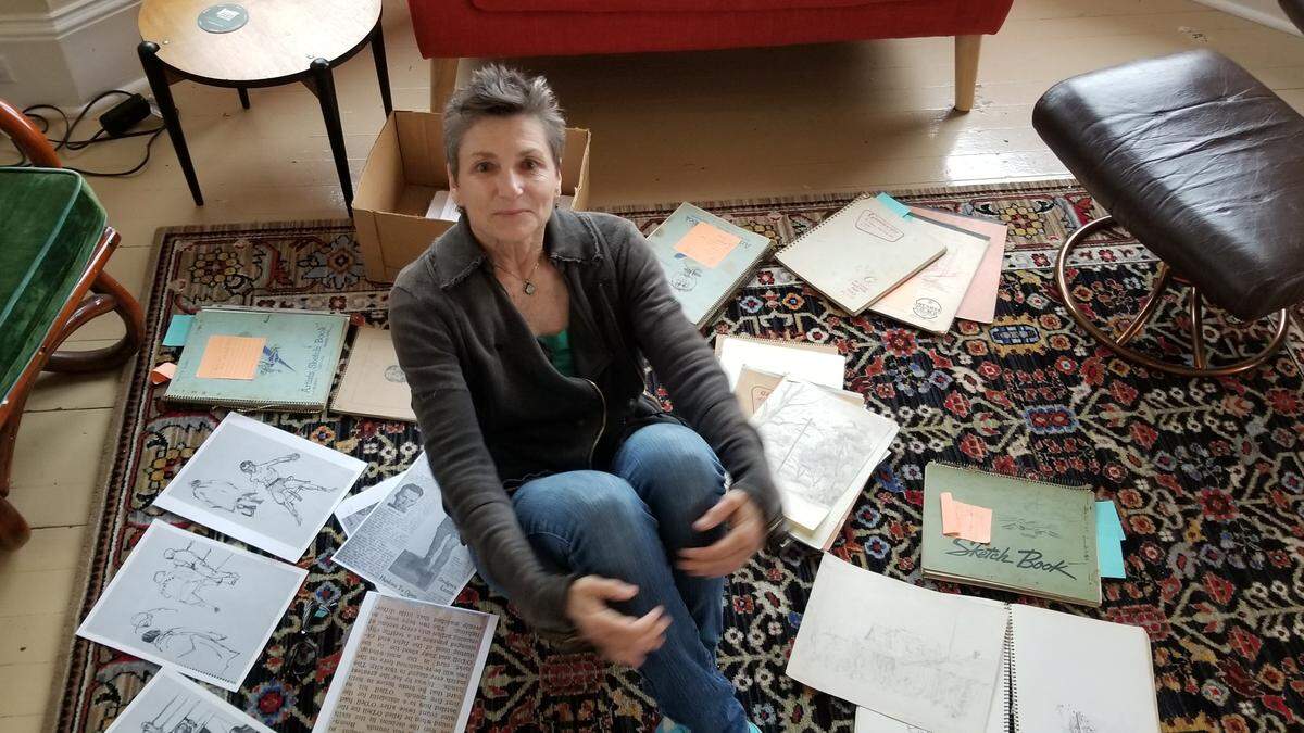 Judith Altruda with Eugene Landry’s sketchbooks.