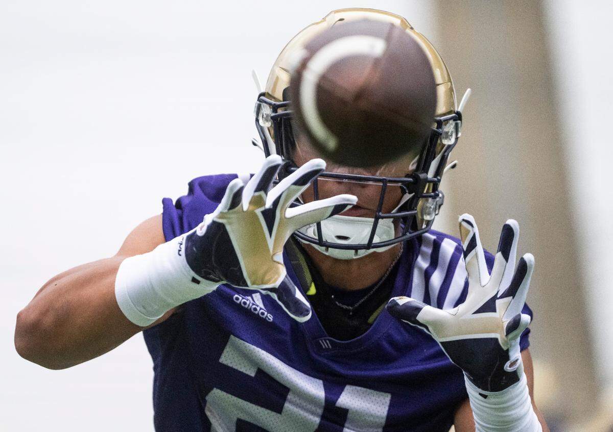 University of Washington Huskies running back Wayne Taulapapa, 21, catches the ball during a drill at the first day of Fall practice at Husky Stadium on Thursday, Aug. 4, 2022 in Seattle, Wash.