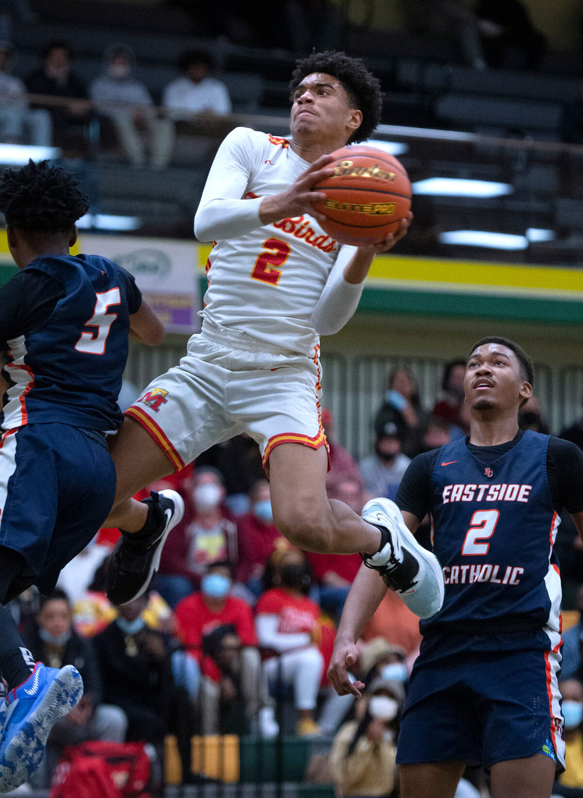 Mount Tahoma’s Josiah Maxey-Johnson flies to the basket between Eastside Catholic defenders Ishe Kanhukamwe (5) and Amari Jackson during Friday night’s boys basketball regional playoff game at Foss High School Tacoma, Washington, on Feb. 25, 2022. Eastside Christian won the game, 68-51.