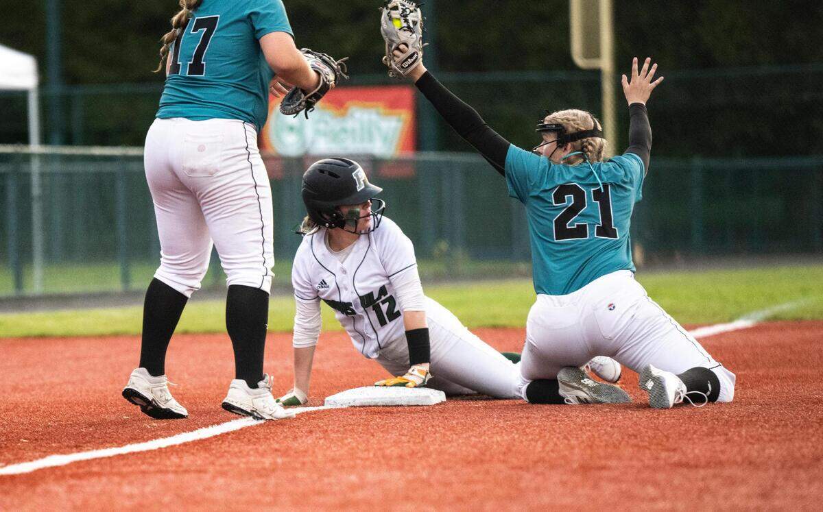 Bonney Lake’s third baseman Bella Jones, 21, tags out Peninsula’s Malia Coit, 12, on third base ending the game with a triple play during the 3A state softball tournament quarterfinals at the Regional Athletic Complex on Friday, May 27, 2022 in Olympia, Wash. Bonney Lake defeated Peninsula 3-2 with a triple play in the seventh inning to win the quarterfinal game.
