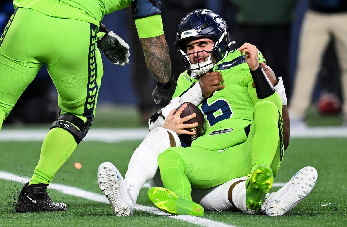 Seattle Seahawks quarterback Sam Howell (6) is sacked by Green Bay Packers linebacker Edgerrin Cooper (56) during the third quarter of the game at Lumen Field, on Sunday, Dec. 15, 2024, in Seattle, Wash.