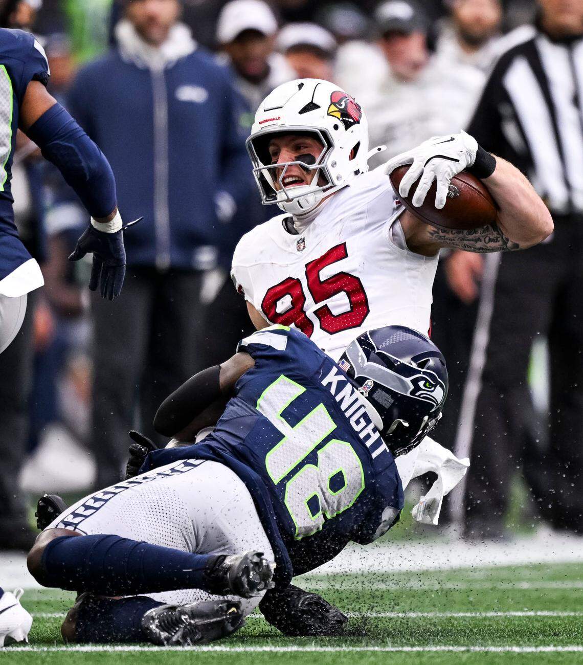 Arizona Cardinals tight end Trey McBride (85) is tackled by Seattle Seahawks linebacker Tyrice Knight (48) during the third quarter of the game at Lumen Field, on Sunday, Nov. 24, 2024, in Seattle, Wash.