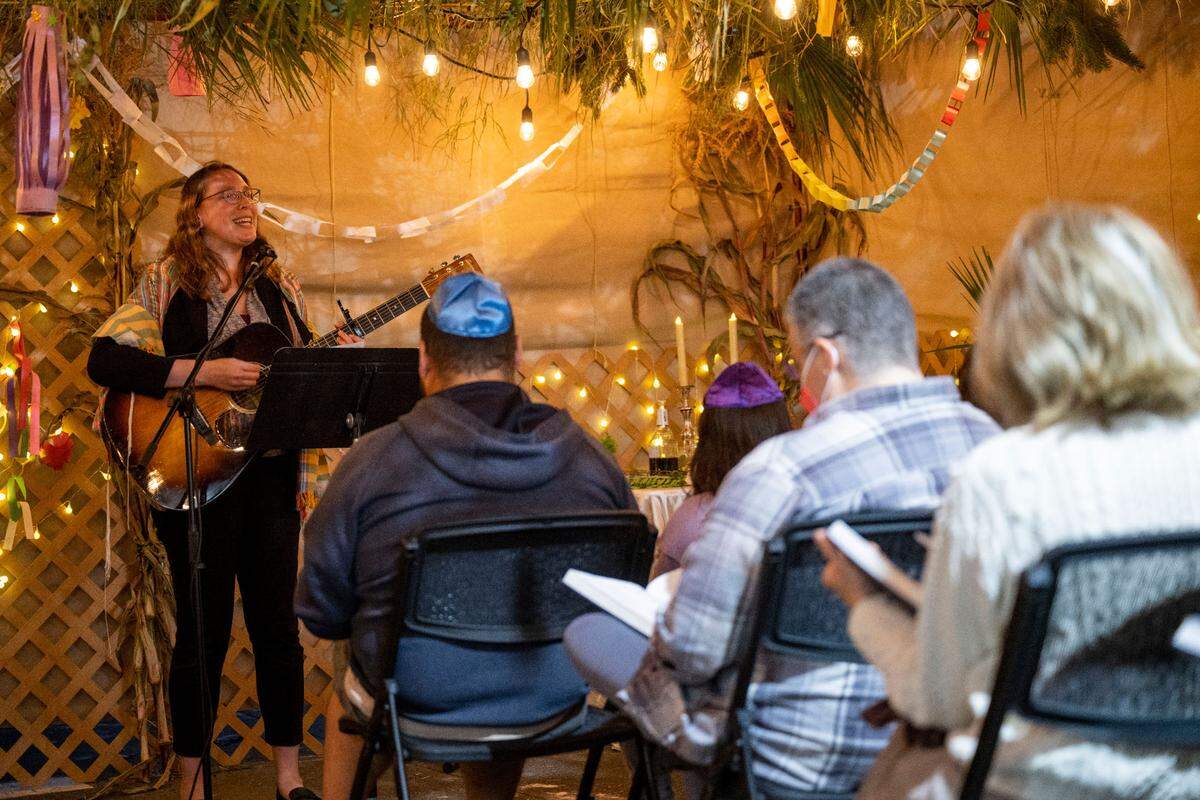 Rabbi Keren Gorban, 37, sings and plays the guitar during a service for the Sukkot holiday on Friday, Oct. 14, 2022, at Temple Beth El in Tacoma. Gorban, who started the position on July 1, was previously the associate rabbi at Temple Sinai in Pittsburgh for seven years.