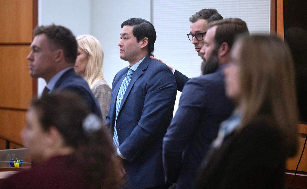 Tacoma police officer Timothy Rankine stands with attorney Mark Conrad as jury questions are answered in Pierce County Superior Court on Wednesday, Dec. 20, 2023.