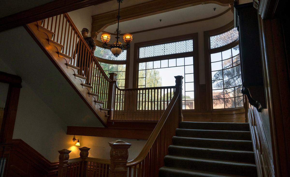Property manager Paula Squillacote walks up the main stairwell at the Blackwell Mansion in downtown Tacoma on Tuesday, Sept. 27, 2022.