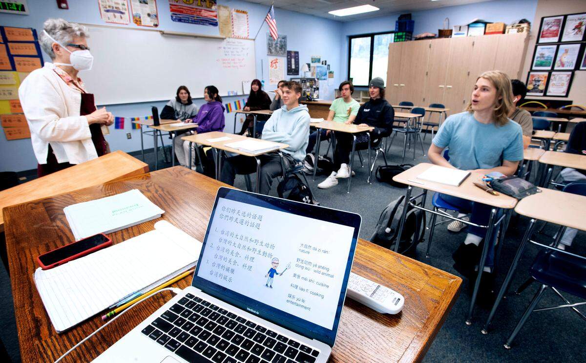 Chinese language teacher Heidi Steele converses with Sean Wurtz, 17, during her Chinese language class at Gig Harbor High School in Gig Harbor, Washington, on Thursday, March 31, 2022.